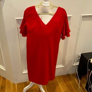 This dress is like new zip in the back V-neck in the front loose fit